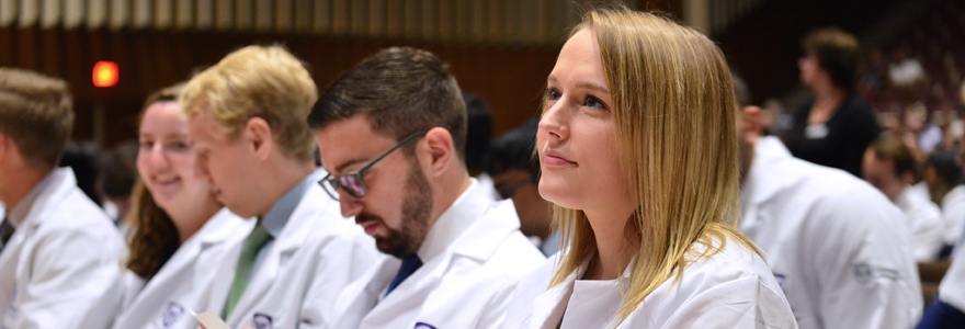Medicine students sitting in their newly minted White Coats